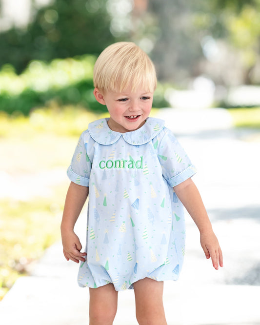 boy wearing a birthday bubble smiling