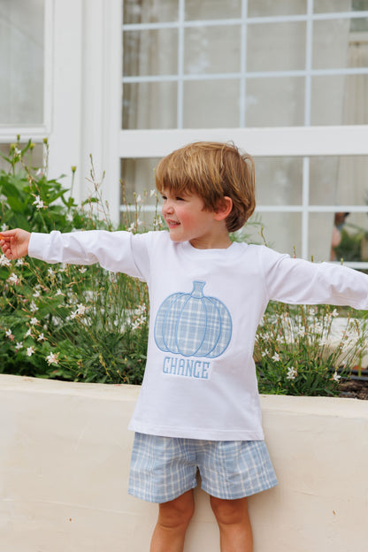 Child wearing a white long-sleeve shirt with a blue pumpkin design and 'CHANCE' text, standing outdoors.