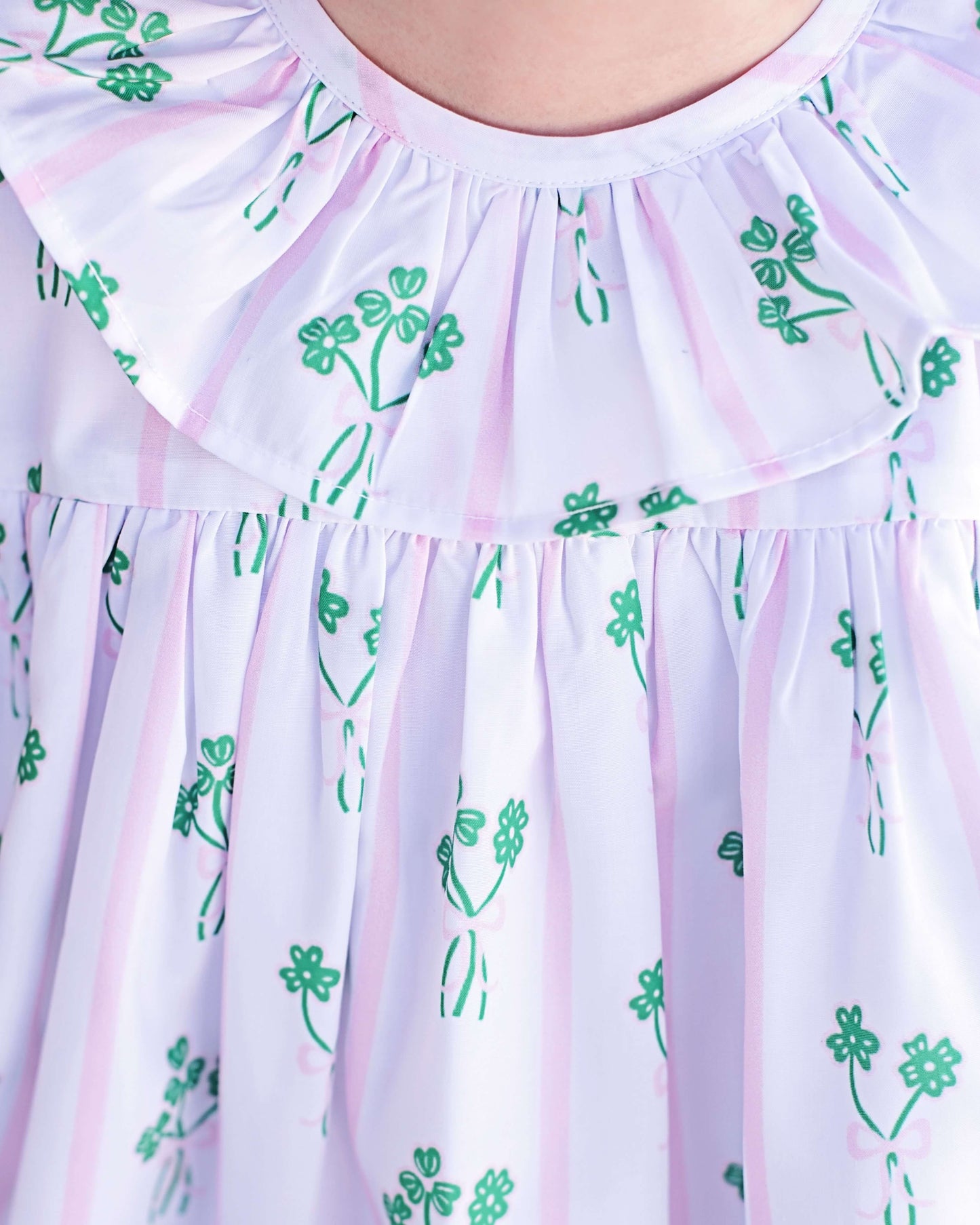 Light purple dress with green floral patterns on a white background