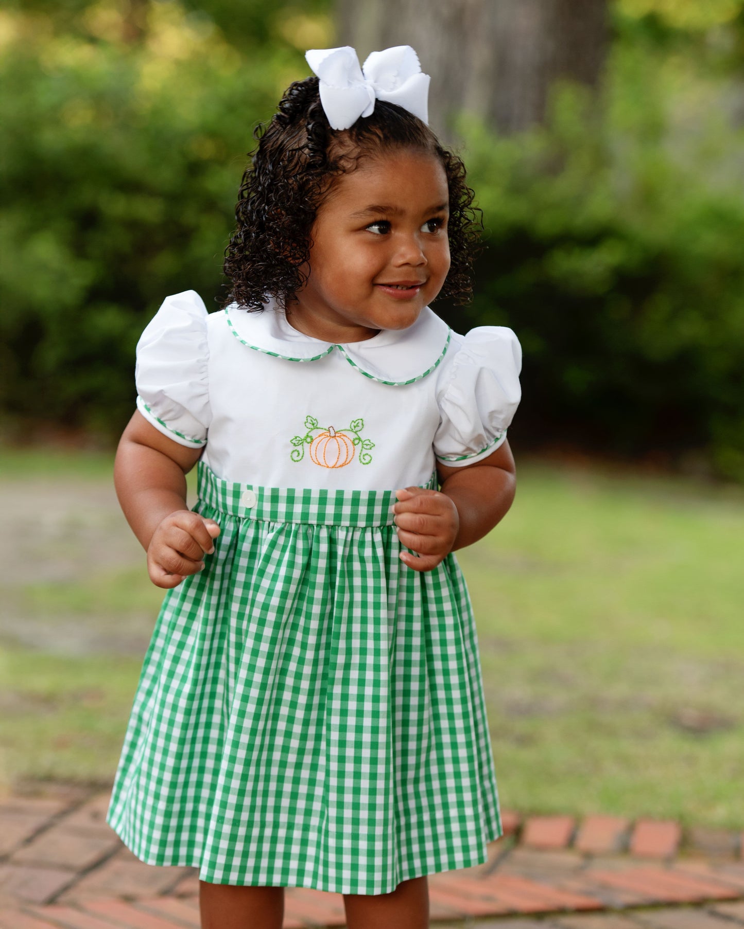 girl with white and green pumpkin check dress