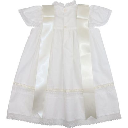 Back view of an ivory heirloom christening dress featuring lace trim, flutter sleeves, and two long satin ribbon bows, showcasing elegant vintage-inspired detailing for special occasions.