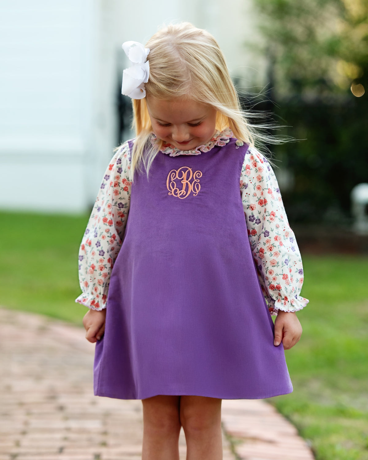 Girl wearing the Lavender Floral Corduroy Dress Set outdoors