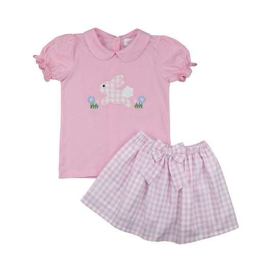 Pink children's outfit with a shirt and skirt on a white background