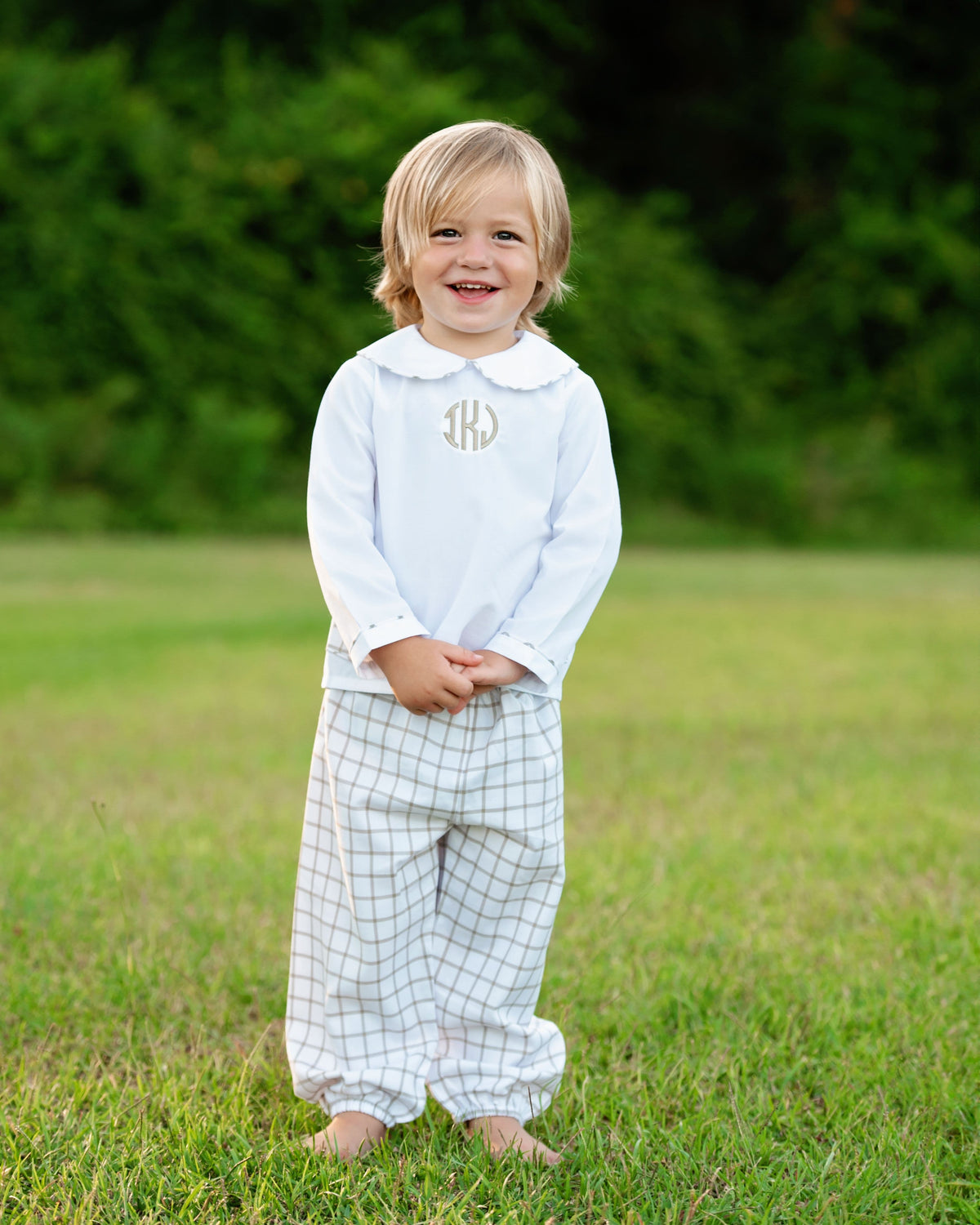 Boy wearing the Khaki Windowpane Ankle Pant Set with monogram outdoors