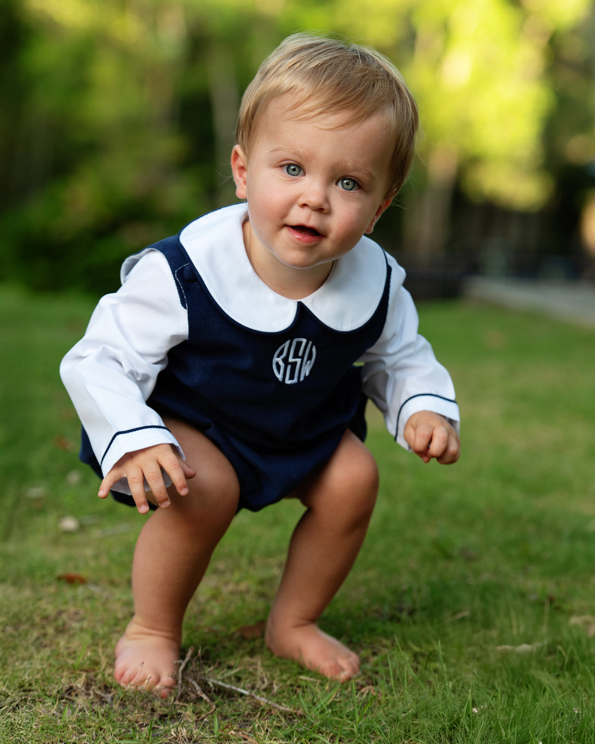 Boy wearing the Navy Corduroy Bubble Set with monogram outdoors