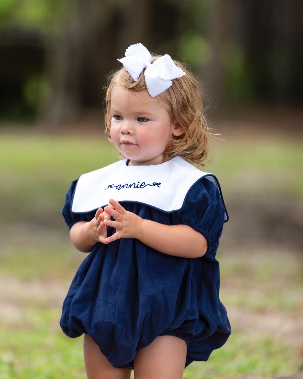 Girl wearing the Navy Corduroy Square Collar Bubble with name personalization